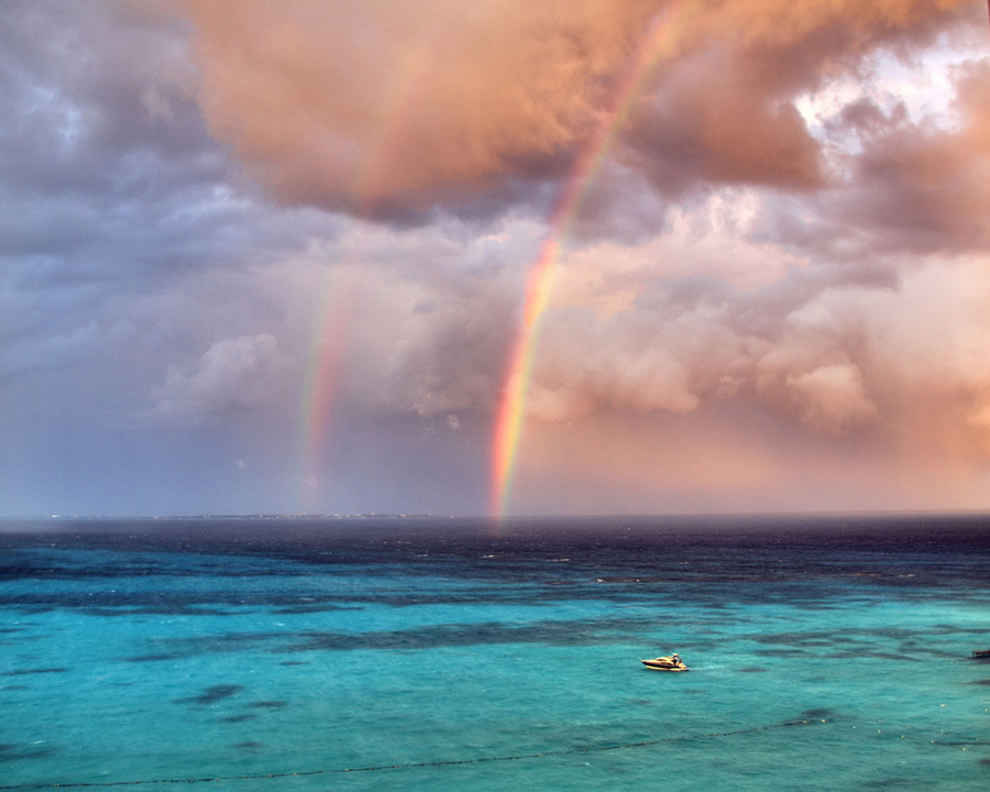 Double rainbow during a stormy Cancun afternoon. “Dare to love yourself as if you were a rainbow with gold at both ends,” wrote Aberjhani in The River of Winged Dreams. Photo #4 by purolipan