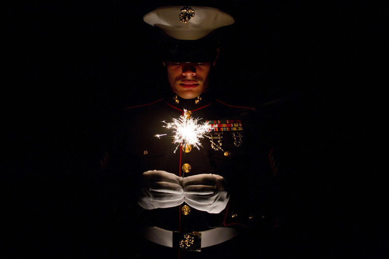 Marine-holding-a-sparkler-celebrating-July-4th